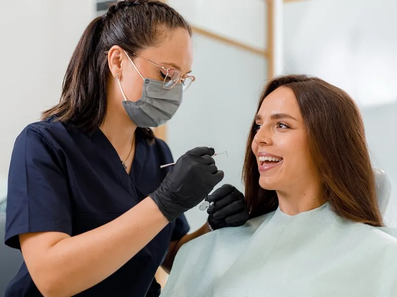 A smiling patient in the dental chair during a relaxed checkup.